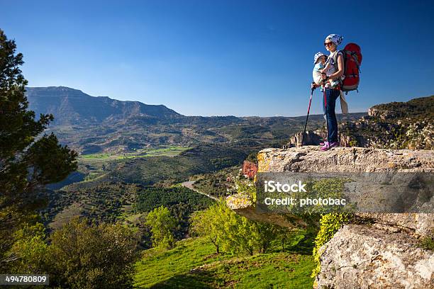Hiker With Baby Relaxing On Cliff And Enjoying Valley View Stock Photo - Download Image Now