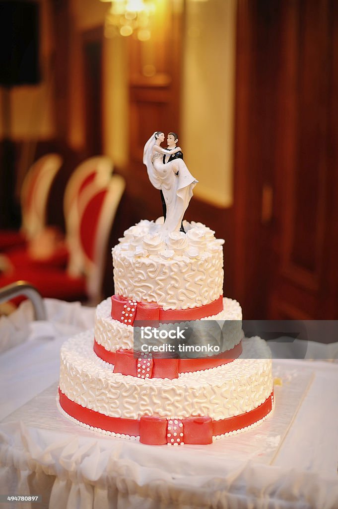 Tre livelli di torta nuziale bianco con rosso nastri - Foto stock royalty-free di Cibo