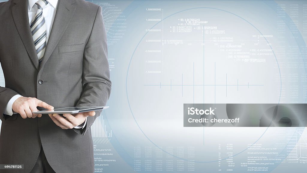 Businessman with tablet pc Businessman holding tablet pc. On background of the high-tech graphs Abstract Stock Photo