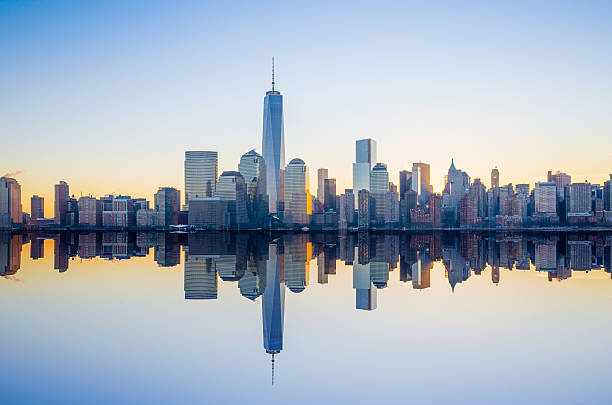 Manhattan Skyline NYC Manhattan Skyline with the One World Trade Center building at twilight, New York City skyline stock pictures, royalty-free photos & images