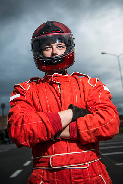 istock Racer wearing red racing protective suit and helmet 494783547