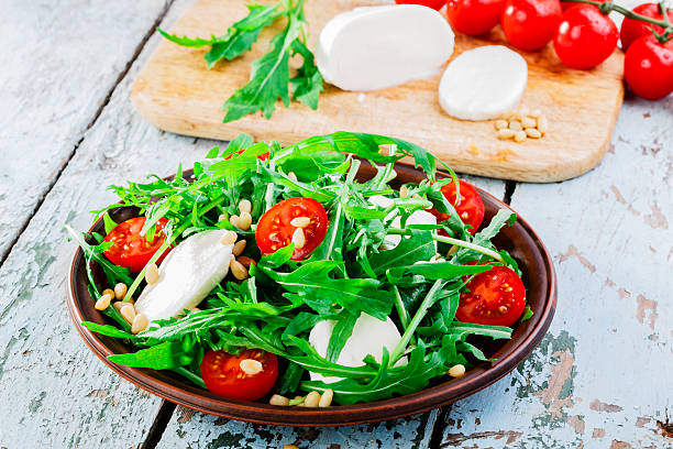 istock arugula salad with mozzarella cheese and cherry tomatoes 494784039