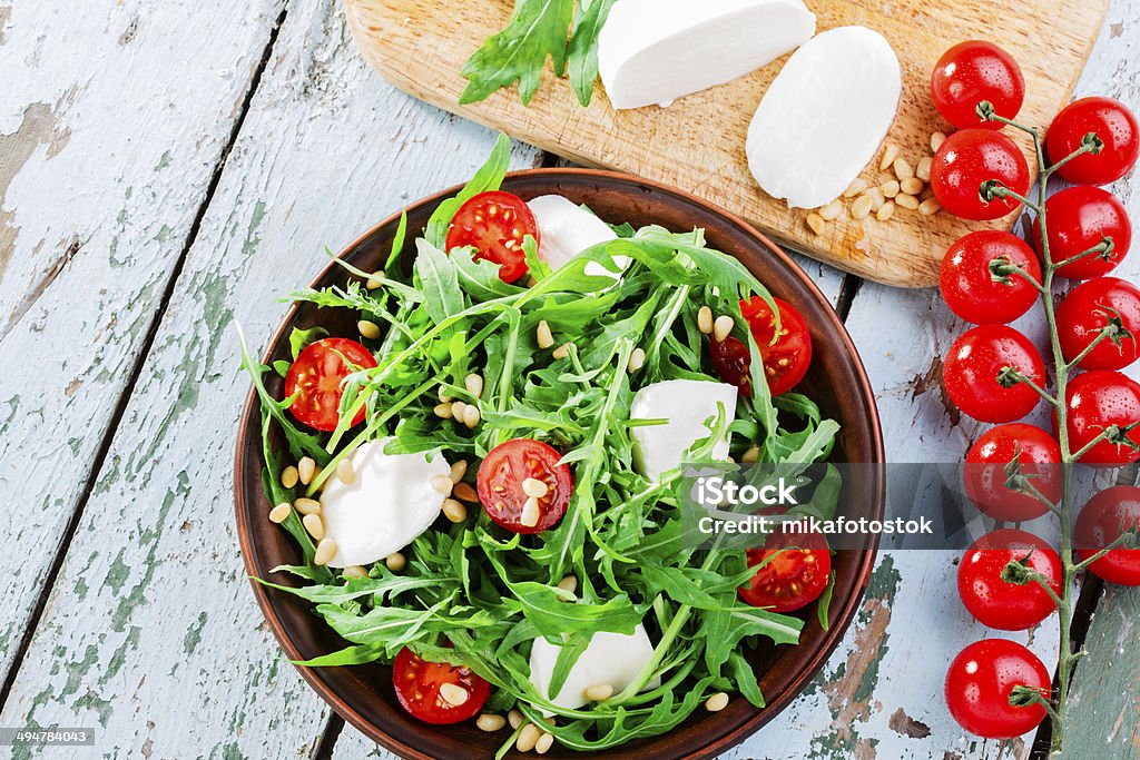 arugula salad with mozzarella cheese and cherry tomatoes Appetizer Stock Photo