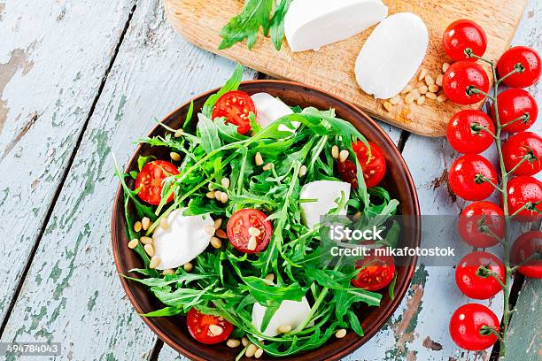 Arugula Salad With Mozzarella Cheese And Cherry Tomatoes Stock Photo - Download Image Now