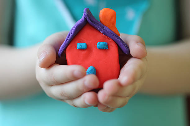 Look what i just made! Little girl holding a plasticine house with her hands. preschooler caucasian one person part of stock pictures, royalty-free photos & images