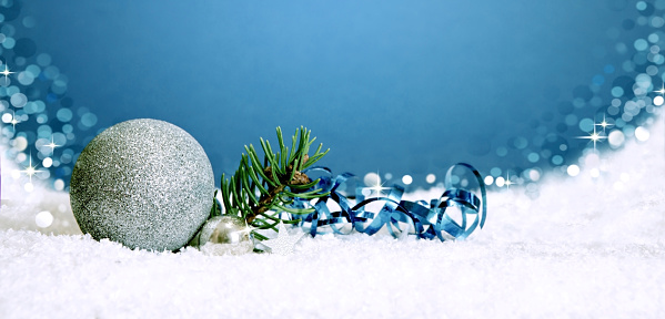 Silver  decorative christmas ball on blue bokeh background.