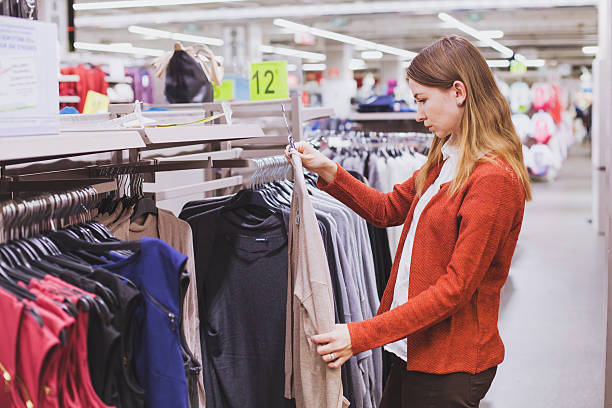 istock woman choosing clothes in big store 494788642
