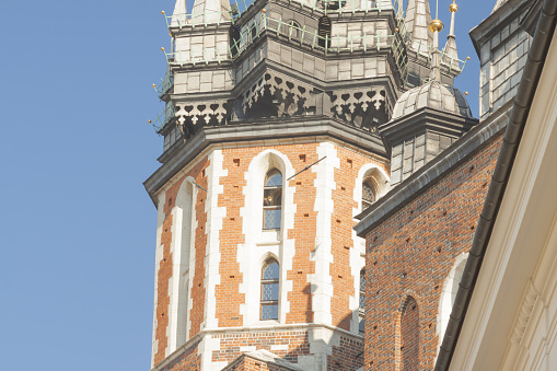 Poland, Krakow, market square, st Mary (Mariacki) church tower, trumpeter playing midday call (hejnal)
