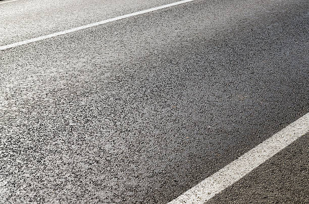 istock asphalt road closeup with white lines 494790890