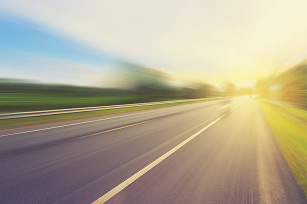 istock Empty asphalt road in motion blur and sunlight 494792322