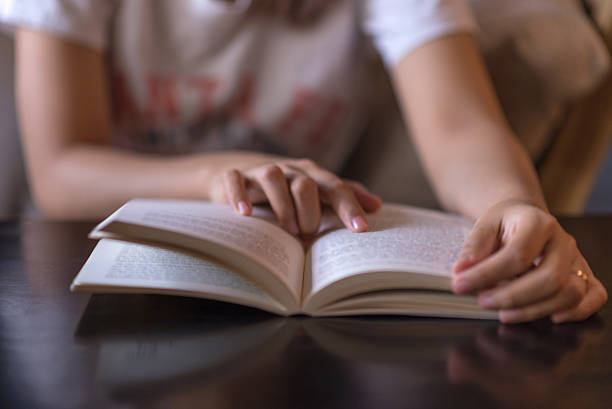 istock Young woman reseearching some important information in a book 494809490