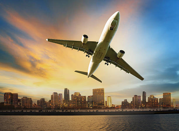istock passenger plane flying against urban scene background 494810391