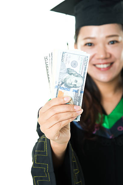 istock Female graduate with money 494810842