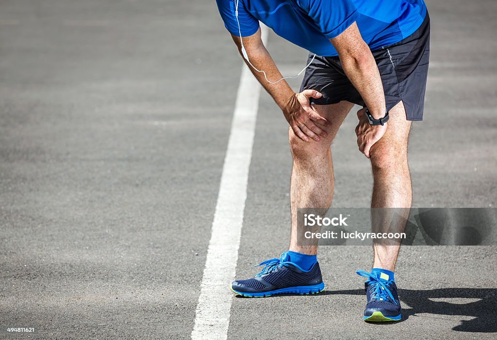 Tired male runner resting after training. Men Stock Photo