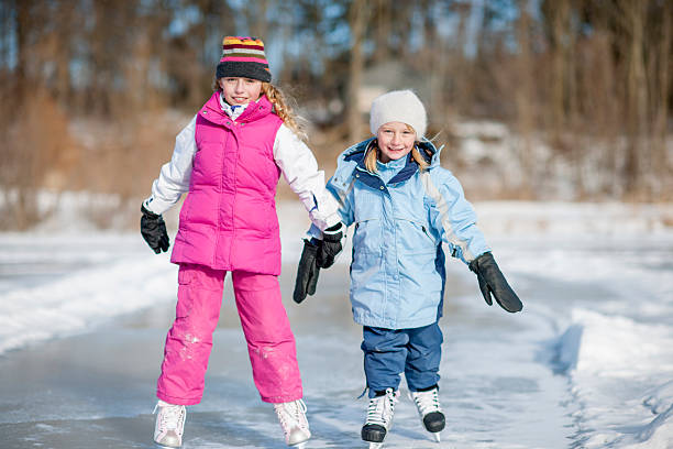 istock Two Sisters are Ice Skating Together at the Pond 494812184