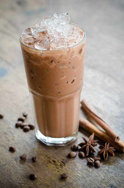 istock iced cocoa in a glass on wood background 494812736