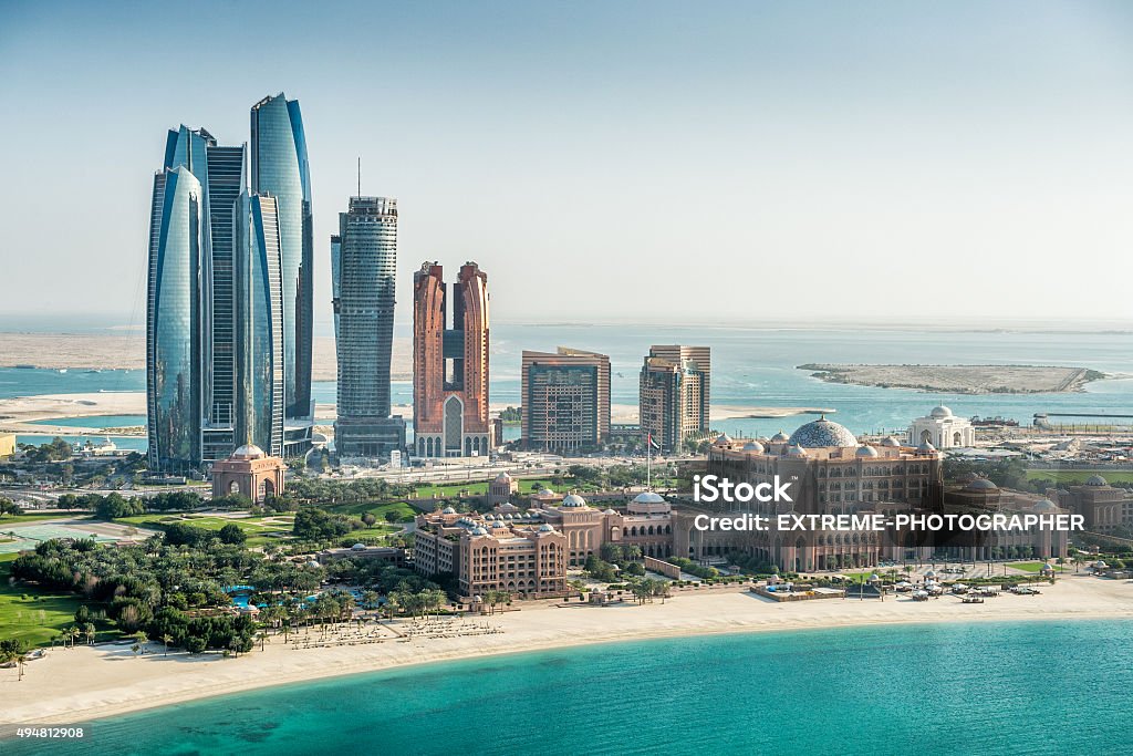 Sea and skyscrapers in Abu Dhabi Helicopter point of view of sea and skyscrapers in Corniche bay in Abu Dhabi, UAE. Turquoise water and blue sky combined with building exterior. Abu Dhabi Stock Photo