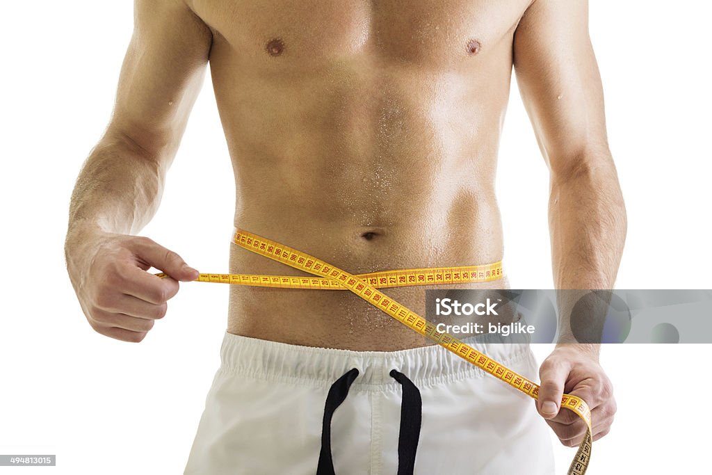 Fit young bodybuilder hombre medir su cintura - Foto de stock de Hombres libre de derechos