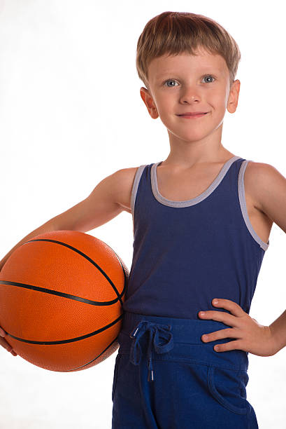 istock The boy held a basketball ball to a hip 494813780