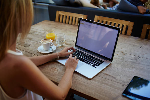 istock Female freelancer using net-book for distance work during morning breakfast 494814276