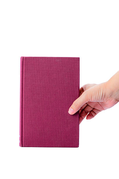 istock Pink book with hand isolated on white background 494814279