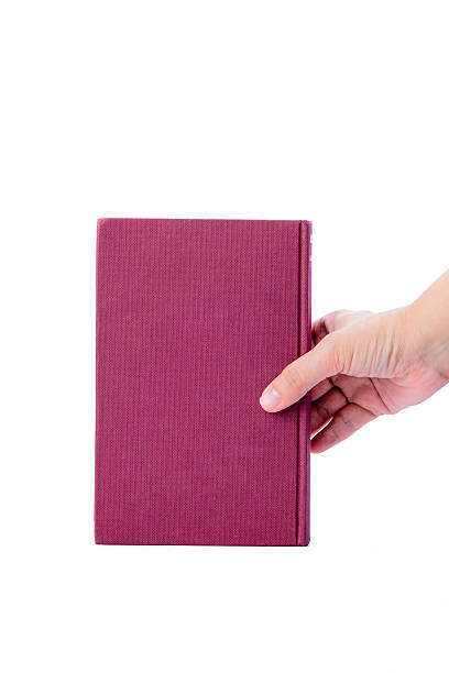 istock Pink book with hand isolated on white background 494815247
