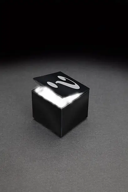 Black box with white glow and question mark