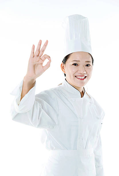 istock Young female chef making OK hand gesture 494826194