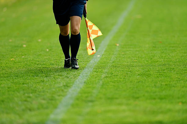 Soccer assistant referee Assistant referee running along the sideline during a soccer match referee stock pictures, royalty-free photos & images
