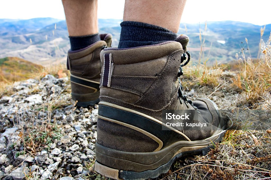 Hiker jumps over stones in Carpathian mountains with foot closeu Hiker jumps over stones in Carpathian mountains with foot closeup 2015 Stock Photo