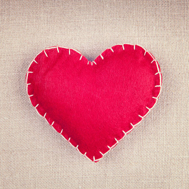 istock Red heart on vintage fabric background 494828452