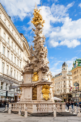 Vienna, Austria - September 27, 2015: memorial Plague column (Pestsaule) and tourists on Graben street Vienna. The Graben is one of the most famous streets in Vienna first district, the city centre.