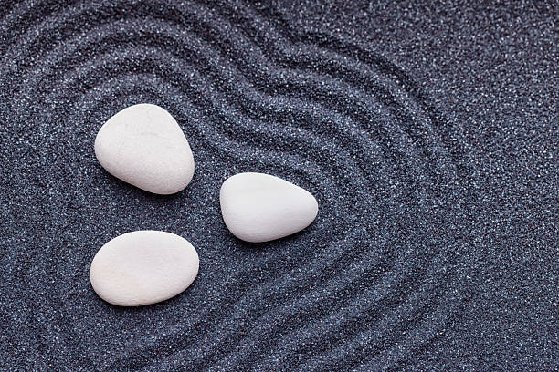 istock Zen garden with a silk white stones with wave patterns 494830140