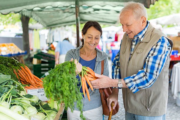 istock Senior man with caregiver shopping 494830202