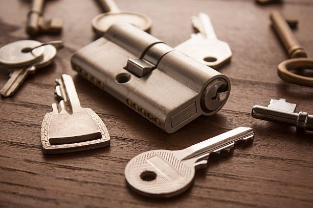 door lock with keys on wooden surface stock photo