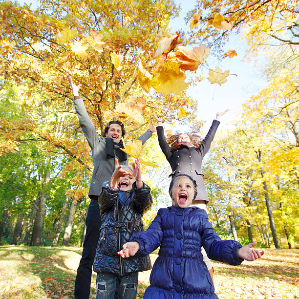 istock Family playing with autumn leaves 494831598