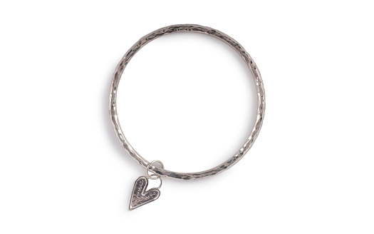 Silver bracelet with heart shaped drop isolated on white