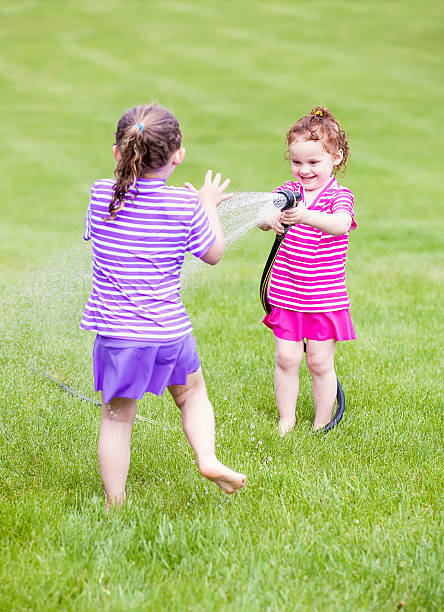 istock Girls Playing With Garden Hose 494833183