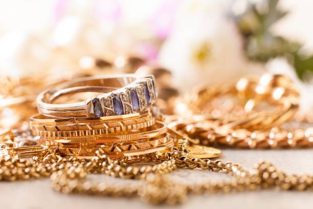 shiny gold and silver jewelery shiny gold and silver jewelery on white table jewelry stock pictures, royalty-free photos & images