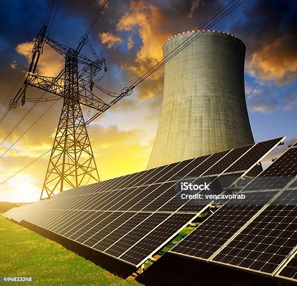 Solar Energy Panels Nuclear Power Plant And Electricity Pylon Stock Photo - Download Image Now