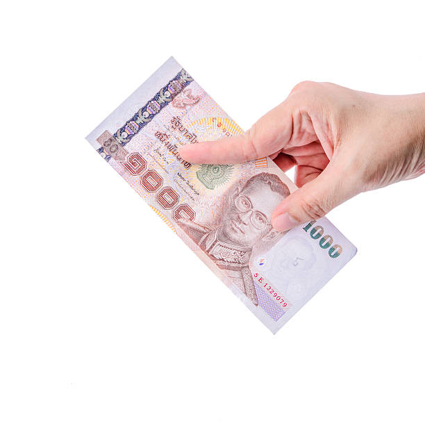 istock Hand holding Thai money isolated on white. 494834021