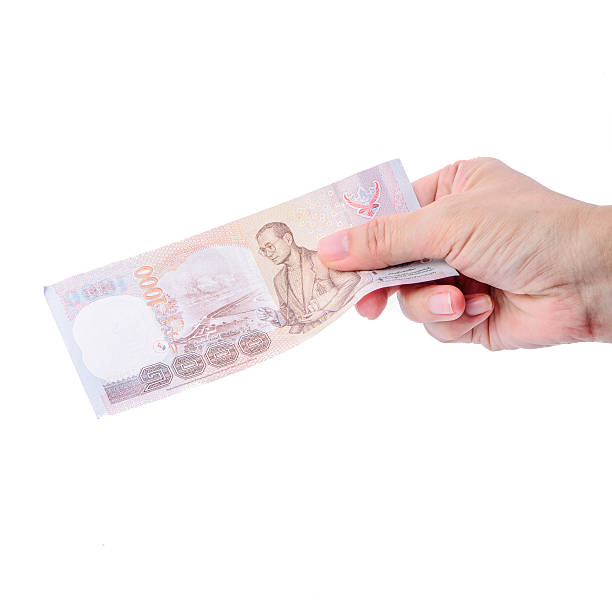 istock Hand holding Thai money isolated on white. 494834023
