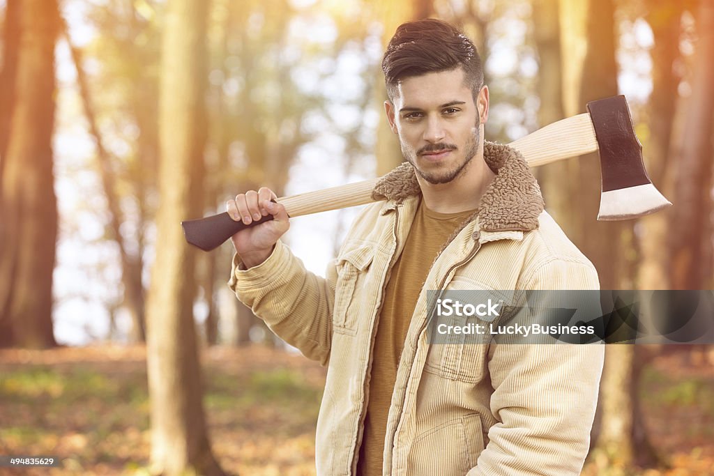 Handsome young men with axe Portrait of handsome young men with axe, looking at camera Adult Stock Photo