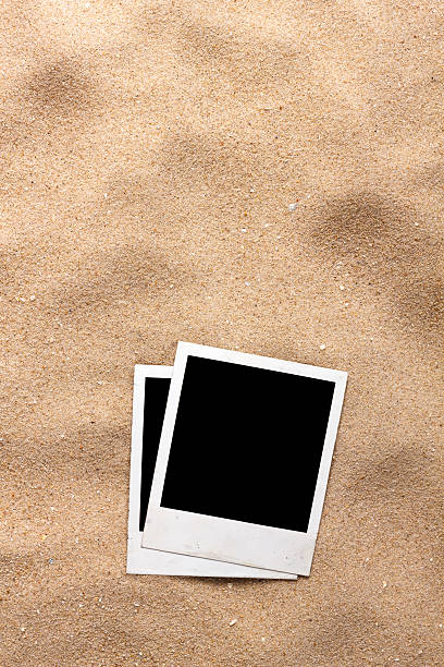 istock Old style empty photo cards lying on a sea sand 494836939
