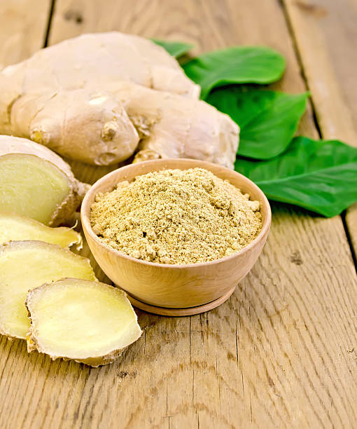 istock Ginger powder in a bowl with the root and leaves 494838207