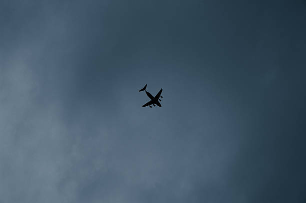 istock silhouette airplane in the sky 494839471