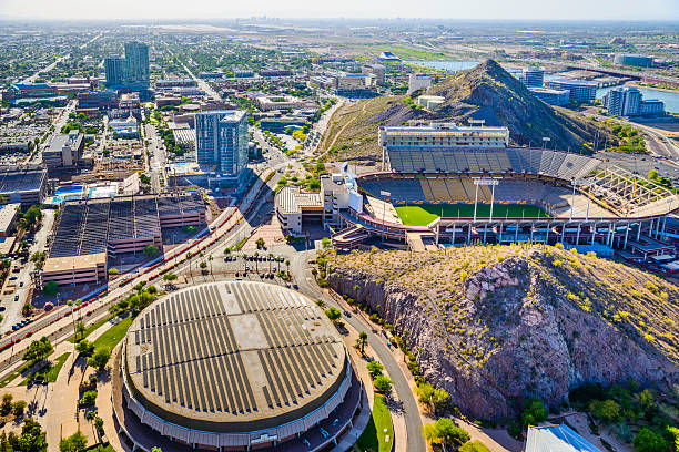 Skyline panoramic aerial helicopter view of Tempe, Arizona. Showing ASU Arizona State University campus with Sun Devil Football Stadium (Frank Kush Field) on middle right and Wells Fargo Arena in bottom left foreground. 