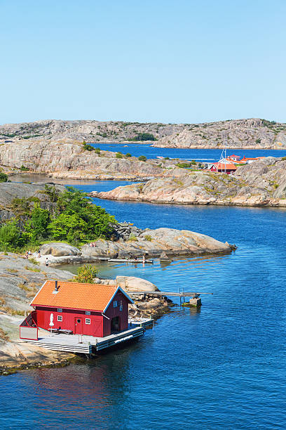 istock Red cottage by the sea 494840175