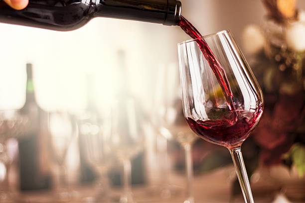 red wine red wine pouring in a restaurant wineglass stock pictures, royalty-free photos & images