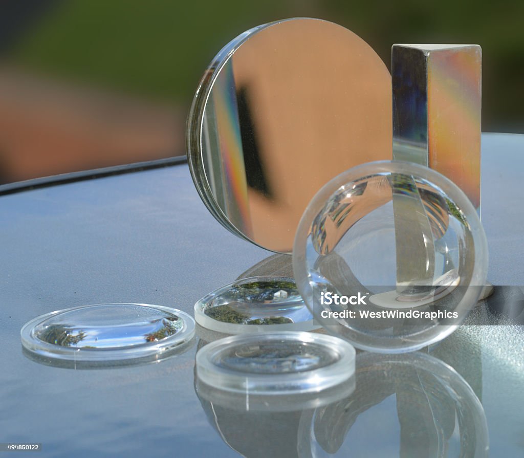 lenses, mirror, and prism An assortment of various lenses, mirrors, and prisms Lens - Optical Instrument Stock Photo